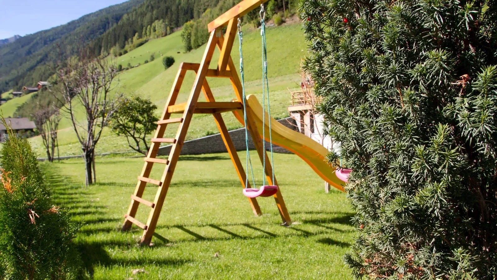 Garten beim Appartement Typ C Dolomiti mit Schaukel und Rutsche